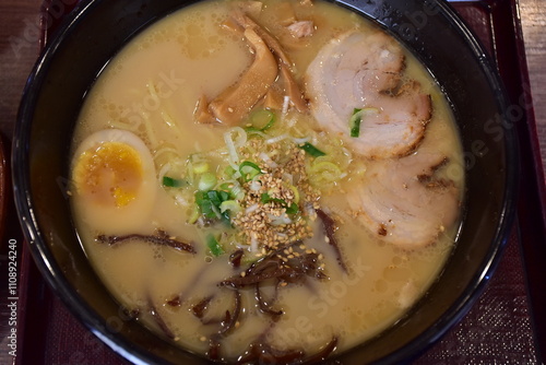 Ramen is a Japanese noodle soup with wheat noodles in a flavorful broth, often topped with meat, eggs, seaweed, and vegetables, blending rich taste and comforting warmth.