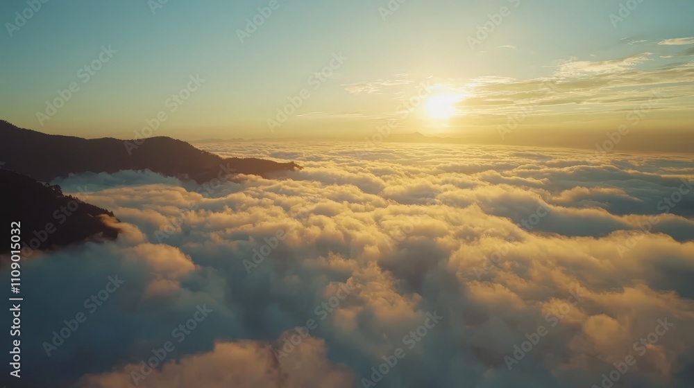Fototapeta premium a stunning view of the sun rising above the clouds from the top of a mountain The sky is a beautiful mix of oranges, pinks, and purples, and the mountains are silh