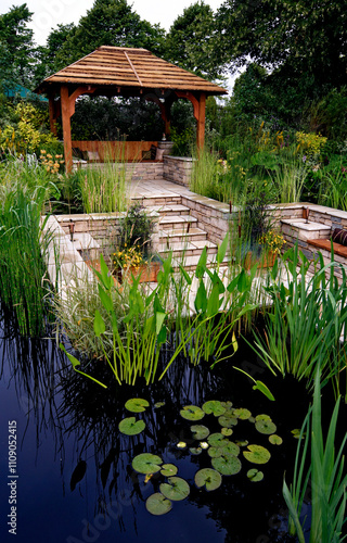 A large pond with sunken patio area