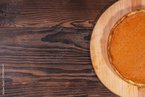 Pumpkin Pie on Rustic Wooden Background with Empty Space