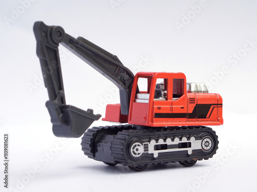 orange excavator or digger toy isolated on white background. heavy construction vehicle miniatur or scale.