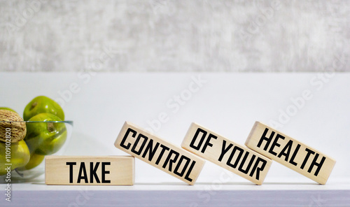 Take control of your health, text with wooden blocks on a white background, the concept of a healthy lifestyle and well-being