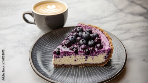 Slice of blueberry cheesecake and cup of coffee