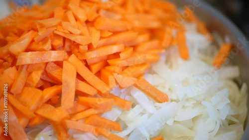 Chopped carrots and cabbage prepared for a dish, close-up view.
