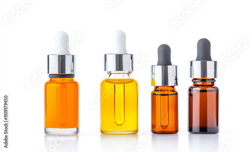 Essential oil droppers on white. Four dropper bottles in different colors sit on a clean, white background, showcasing distinct essential oils.