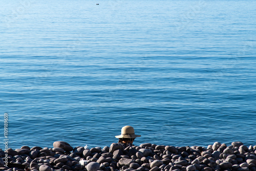 tranquil pebble beach with a tourist photo