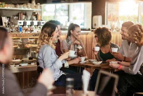 Diverse group of young people talking and having a coffee at a cafe