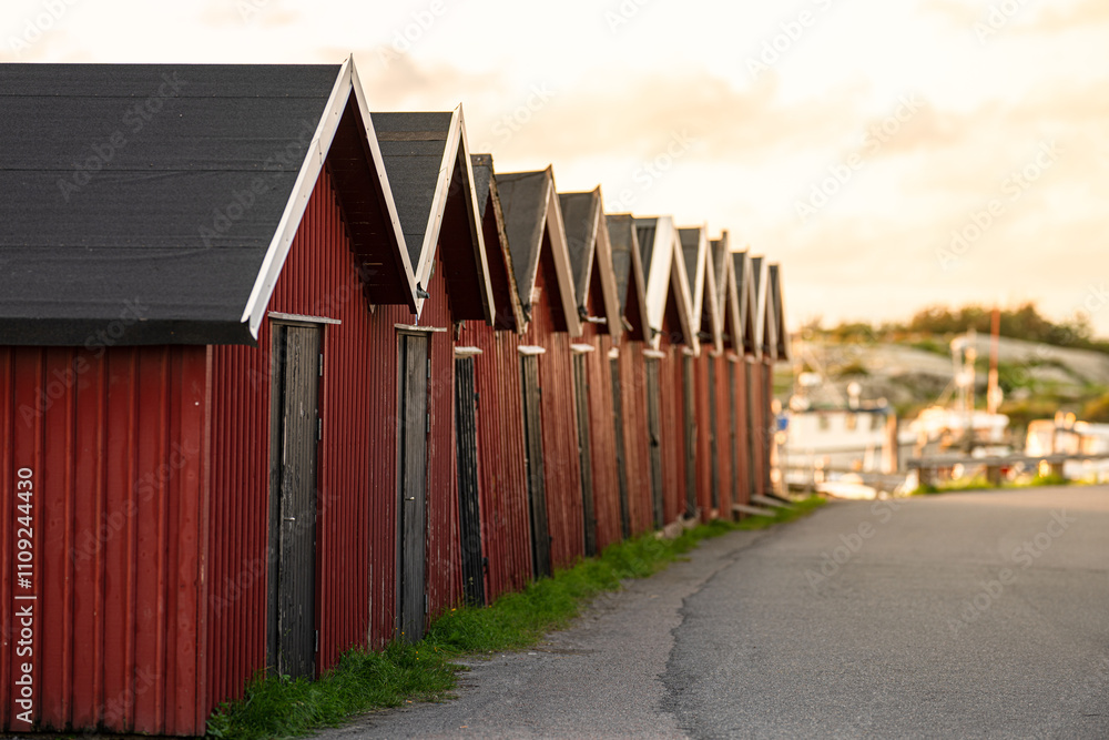 Fototapeta premium Long row of red boat houses.