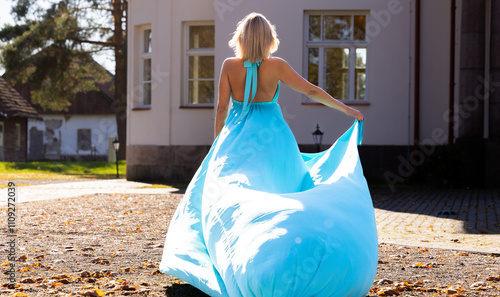 Autumn Fashion Photoshoot: A Beautiful Woman and a Wind-Swept Blue Dress