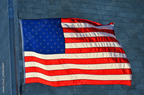 American flag on Washington Monument background - Washington D.C. United States photo