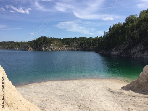 Serene lakeside view with clear waters and trees photo