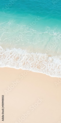 Soft blue ocean wave gently rolling onto a clean sandy beach, creating a serene and peaceful summer scene, peaceful