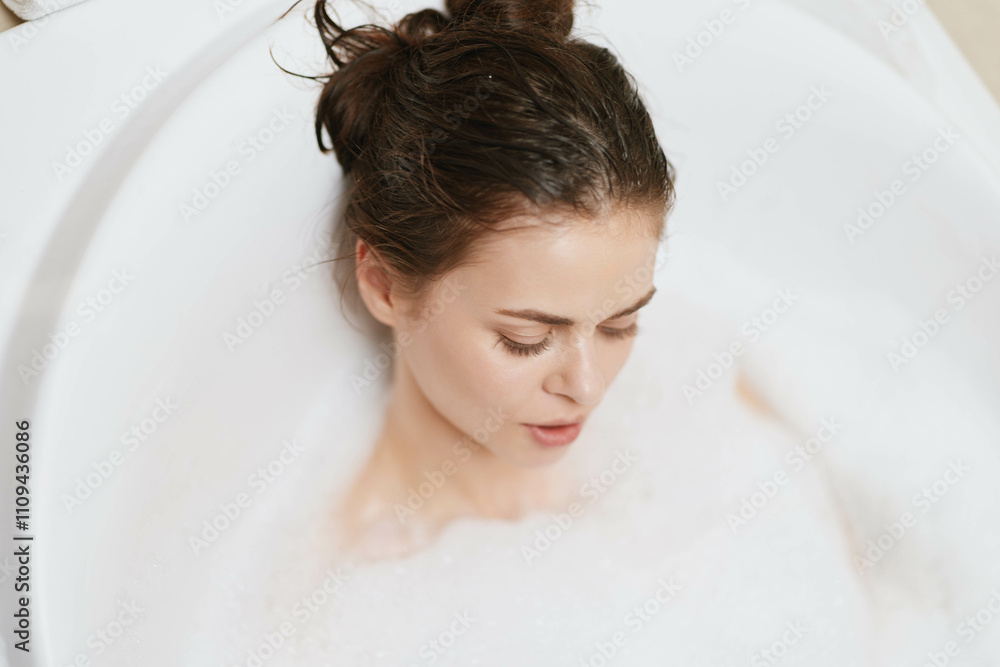 Relaxed young woman enjoying a bubble bath, with soft lighting and calming atmosphere. Self-care and wellness concept for home spa day. Relaxed young woman enjoying a bubble bath, with soft lighting and calming atmosphere. Self-care and wellness concept for home spa day.