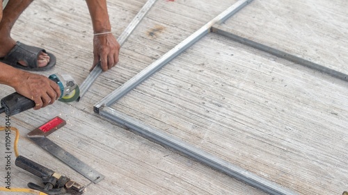 Wallpaper Mural A male worker uses a grinder to sharpen a steel edge. Torontodigital.ca