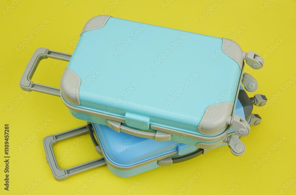 Close up of blue travel suitcases on yellow background. Close up of blue travel suitcases on yellow background.