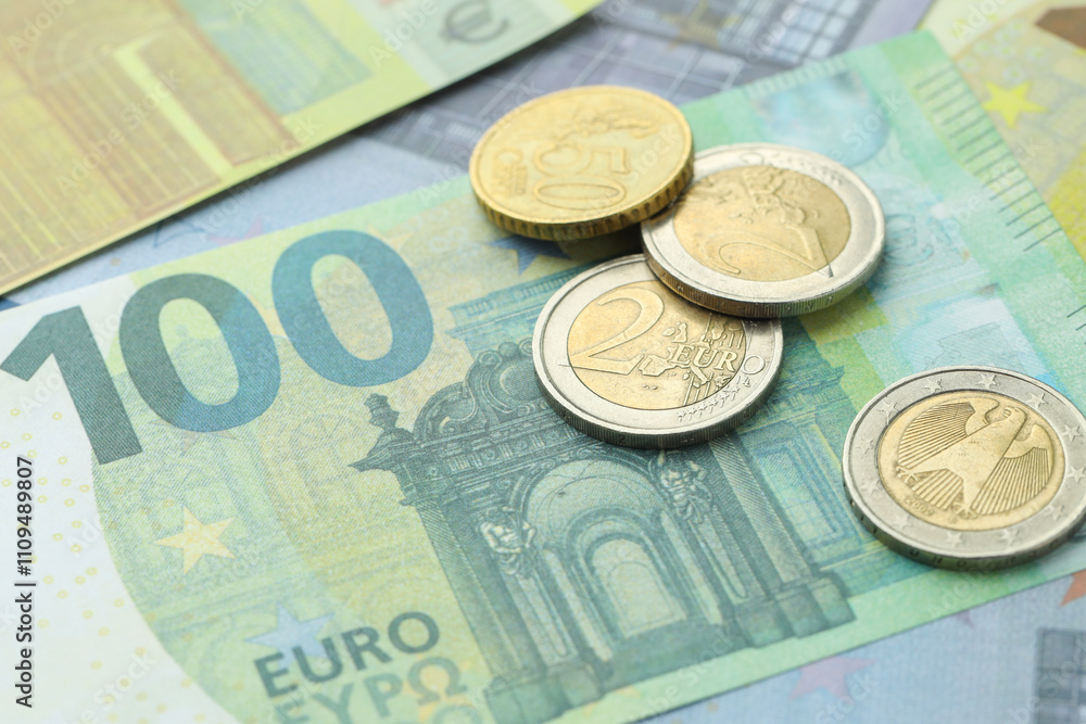 Different coins on euro banknotes, closeup view Different coins on euro banknotes, closeup view