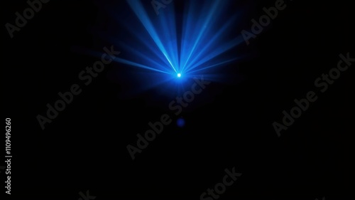 A bright blue light emanating from a projector in a dark room with the light rays projecting out and downward.