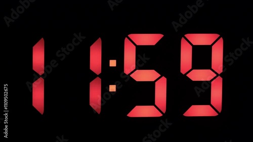 Digital clock displays the time 1159 in bright red as the countdown to midnight approaches, highlighting the excitement of New Year's Eve celebrations