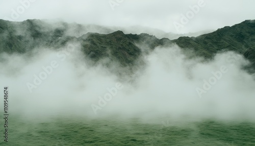 Misty mountain landscape with green valley.