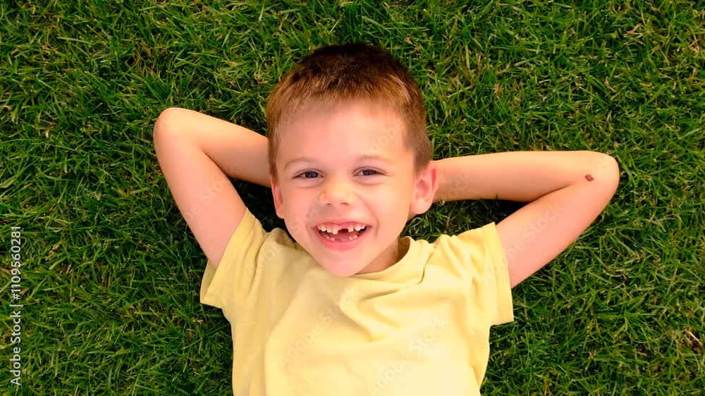 Children are lying on the grass. Selective focus. Children are lying on the grass. Selective focus.