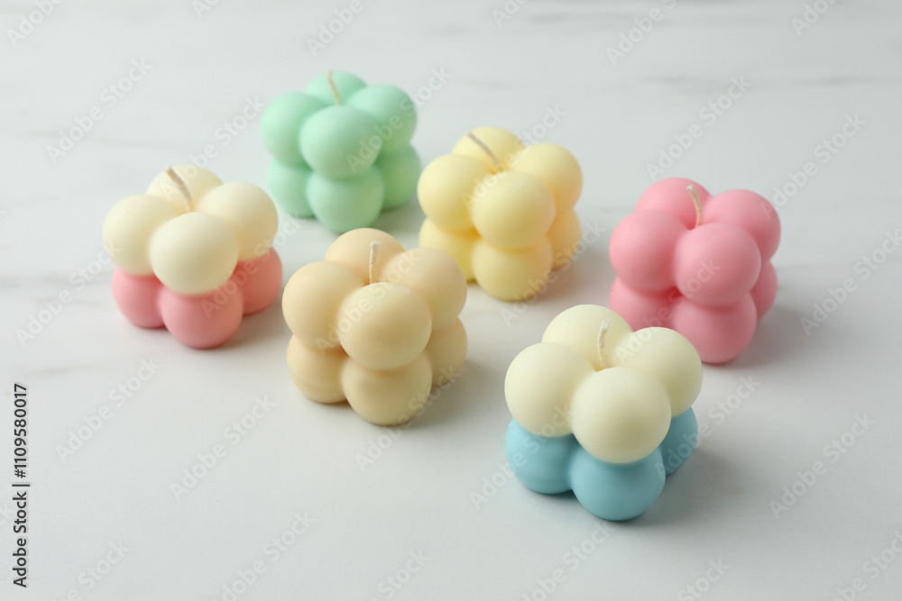 Different stylish bubble candles on white marble table, closeup Different stylish bubble candles on white marble table, closeup