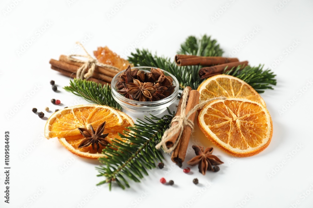 Different spices, dried orange slices and fir tree branches on white table. Christmas season Different spices, dried orange slices and fir tree branches on white table. Christmas season