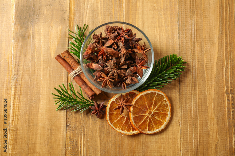 Different spices, dried orange slices and fir tree branches on wooden table, flat lay. Christmas season Different spices, dried orange slices and fir tree branches on wooden table, flat lay. Christmas season