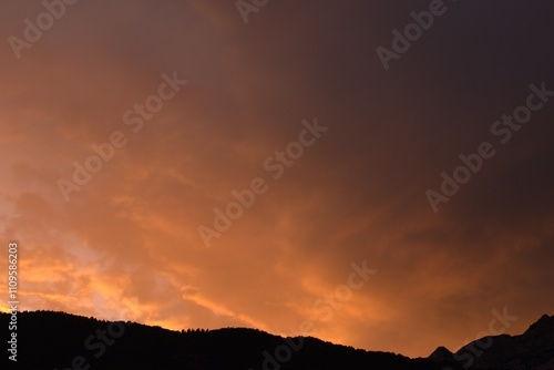 Mountains at sunset with a heavy cloudy sky, Trentino Alto Adige, Italy