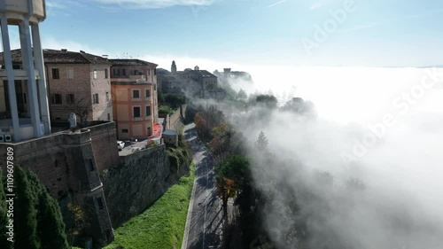 Majestic fog rolling over the hillside in an Italian town