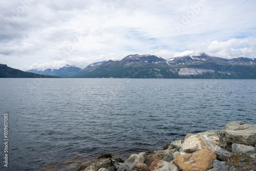 Mountains, fjord and blue sky in Norwegian landscape in Svensby, Norway photo