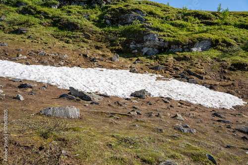 Patch of snow in summer at Mount Storsteinen in Tromso, Norway photo