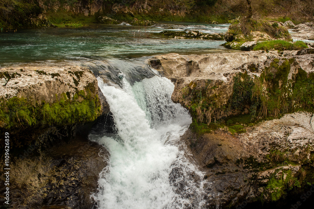 Experience the Serene Waterfall as it Cascades Beautifully Over Rocky and Rugged Terrain Experience the Serene Waterfall as it Cascades Beautifully Over Rocky and Rugged Terrain