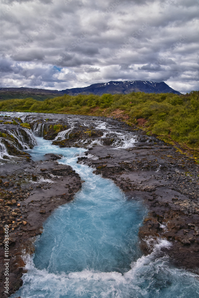 Fototapeta premium Bruarfoss or Bridge Falls, small hidden waterfall blue striking color, Iceland’s Bluest Waterfall, along Bruara river. Golden Circle South Iceland
