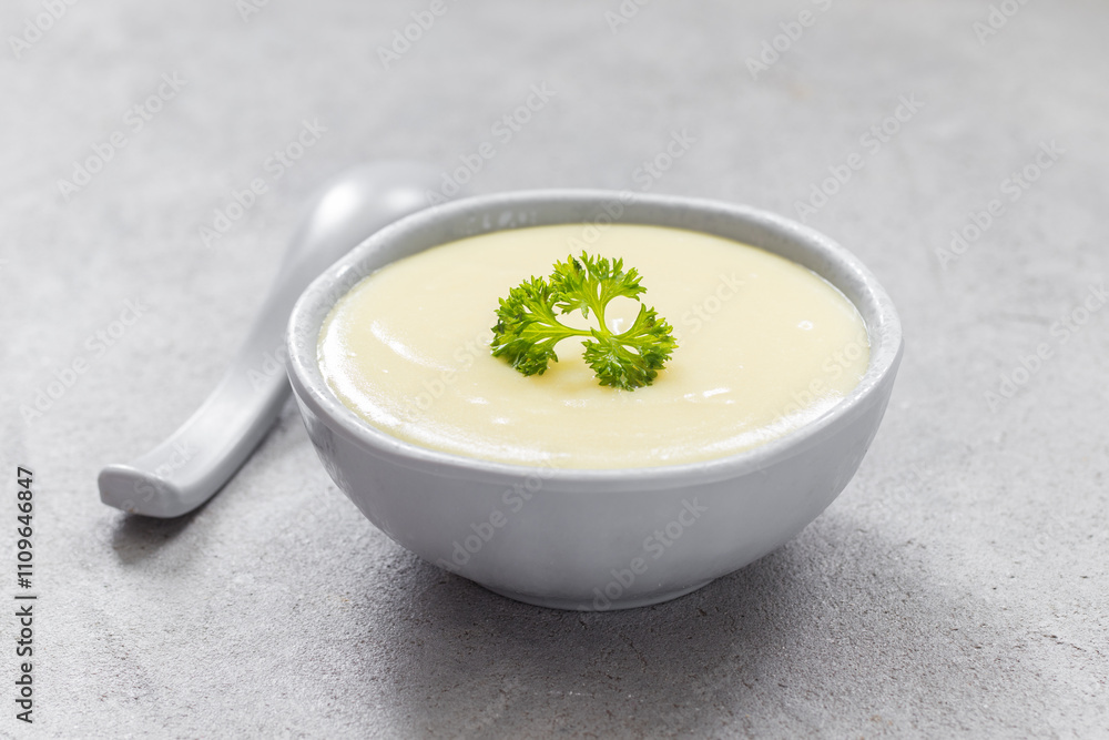 Potato cream soup in a bowl. With parsley. Close-up Potato cream soup in a bowl. With parsley. Close-up