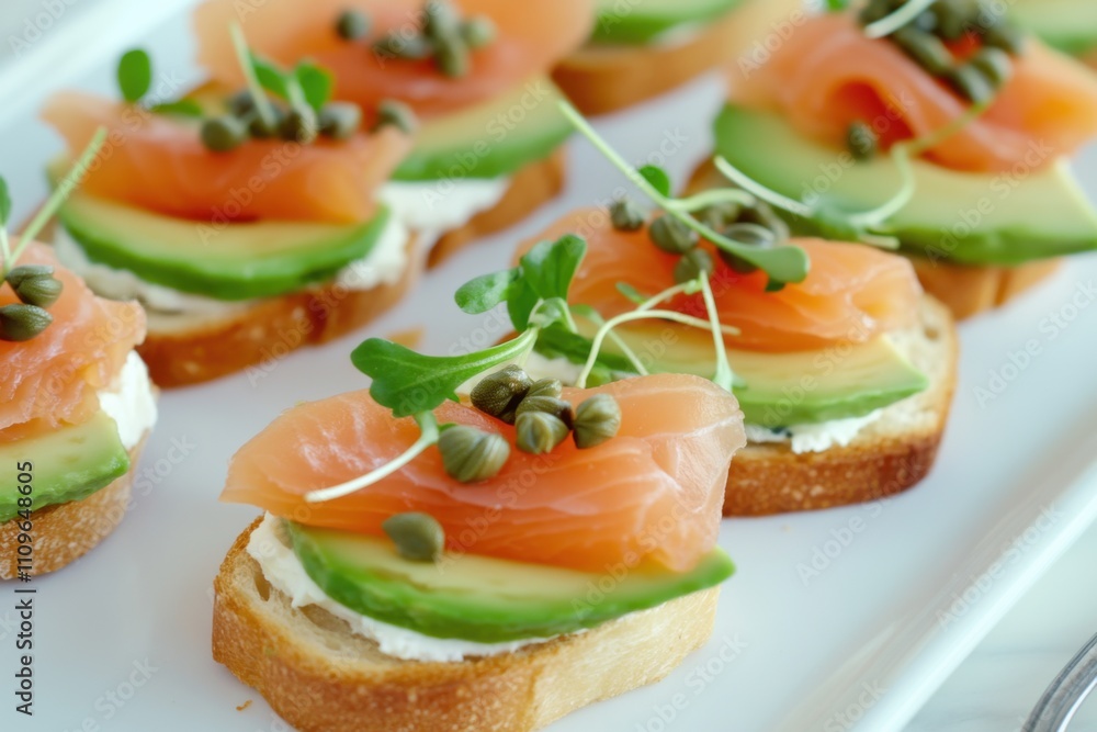Elegant appetizer platter featuring toasted baguette slices with smoked salmon, capers, and avocado for a sophisticated gathering Elegant appetizer platter featuring toasted baguette slices with smoked salmon, capers, and avocado for a sophisticated gathering
