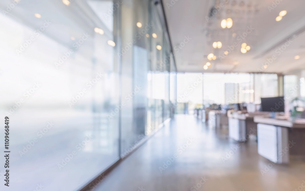 An empty, light-filled corridor in a modern office building with glass room seperators An empty, light-filled corridor in a modern office building with glass room seperators
