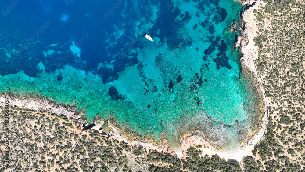 Aerial drone photo from tropical exotic paradise secluded rocky island bay with deep turquoise sea forming a blue lagoon visited by yachts and sail boats in Caribbean exotic destination