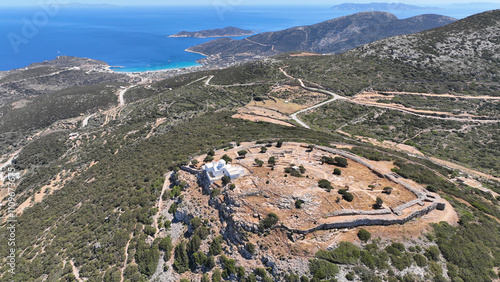 Aerial drone photo of archaeological site of the Mycenaean Citadel and chapel of Agios Andreas built on top of hill overlooking the Aegean sea, Sifnos island, Cyclades, Greece