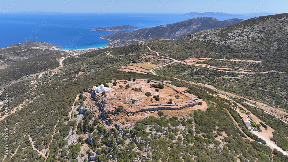 Aerial drone photo of archaeological site of the Mycenaean Citadel and chapel of Agios Andreas built on top of hill overlooking the Aegean sea, Sifnos island, Cyclades, Greece