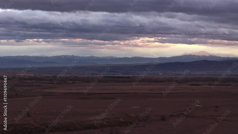An incredibly Dramatic Landscape featuring a Beautiful Cloudy Sky observed at Dusk An incredibly Dramatic Landscape featuring a Beautiful Cloudy Sky observed at Dusk