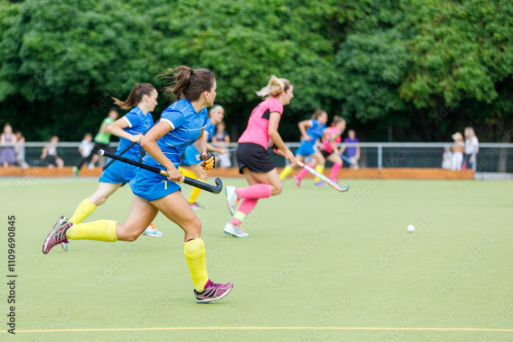 Action-packed field hockey match with players in colorful uniforms competing Action-packed field hockey match with players in colorful uniforms competing