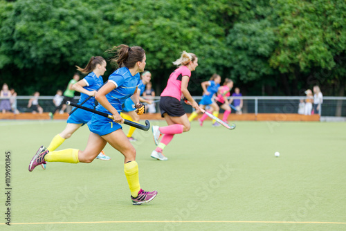 Action-packed field hockey match with players in colorful uniforms competing