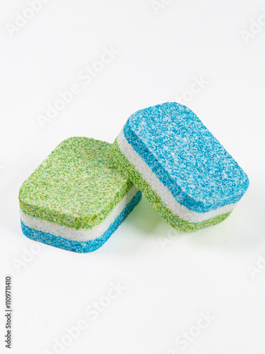 Tablets for washing dishes in the dishwasher. Two tablets isolated on a white background.