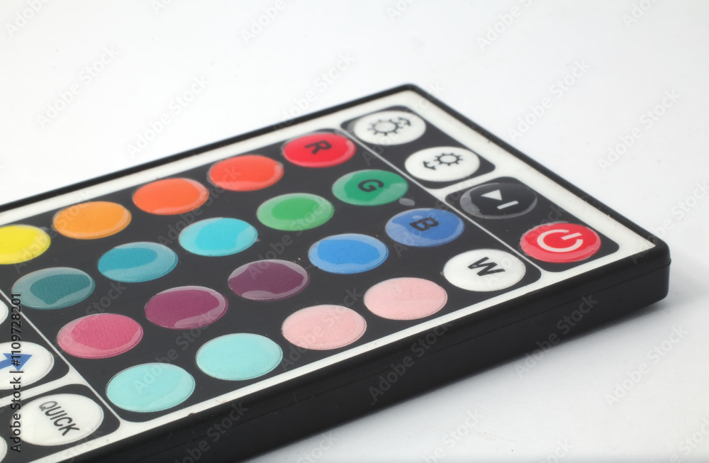 A remote control for rgb lights on a white background. Used to control the color of the rgb led lights in a room, terrace, garage, or living room. A remote control for rgb lights on a white background. Used to control the color of the rgb led lights in a room, terrace, garage, or living room.