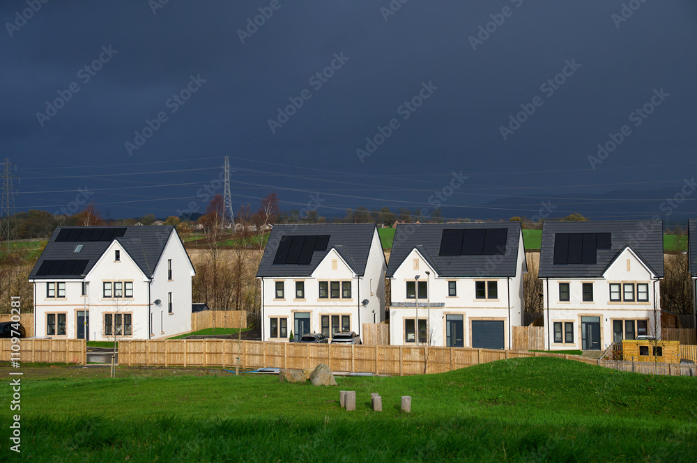Solar panels installed on home roofs at new housing development Solar panels installed on home roofs at new housing development