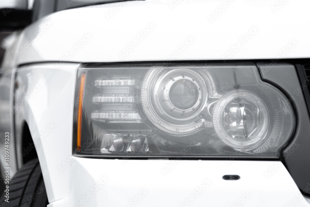 Fototapeta premium white car headlight, close up view, car dealing and manufacturing, cropped car image