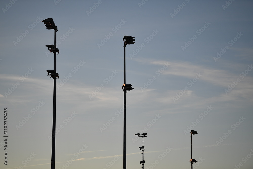 Light poles of a soccer pitch in the evening sun Light poles of a soccer pitch in the evening sun