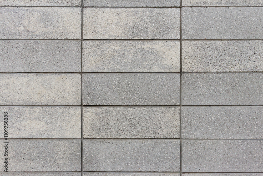 Straight on view of a wall made of grey concrete block Straight on view of a wall made of grey concrete block