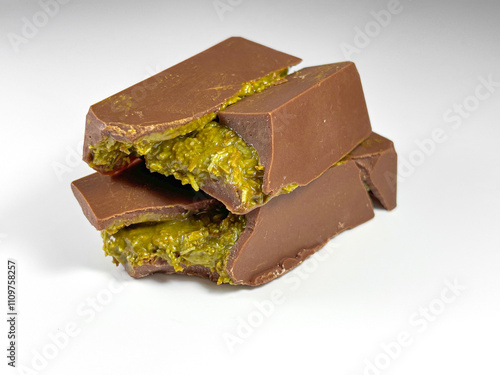 On white background lies Dubai chocolate with pistachio paste and kataifi dough photo