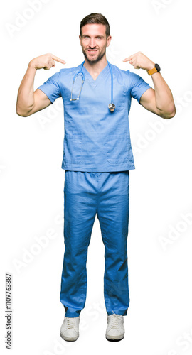 Handsome doctor man wearing medical uniform over isolated background looking confident with smile on face, pointing oneself with fingers proud and happy.